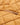 Close-up of an orange quilted jacket lining with a small concealed zip pocket.