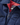 Close-up of the navy jacket’s front zipper and collar area, highlighting the red quilted lining inside.