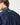 Rear close-up of model wearing a men's sailing smock, highlighting high collar and Henri-Lloyd patch detail on upper back.