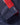 Adjustable navy cuff tab with DRI PRO branding and contrasting red and navy sleeve panel stitching on the sailing jacket.