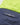 Close up of the Henri Lloyd woven brand tab on the back of a navy sailing jacket with a high visibility yellow hood section.
