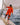 Person standing on a yacht deck adjusting ropes while wearing waterproof sailing jacket and trousers.