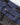 Close-up of Henri-Lloyd branded zip puller on a waterproof jacket pocket for secure, easy access in all conditions.