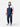 Model standing at an angle wearing the Henri-Lloyd sailing jacket with matching navy sailing trousers.