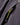 Close-up of zipped side pocket on the Dynamic Smock in Black with lime green zip puller.