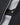Detail of storm flap and snap closure on the Men's Dynamic Jacket in black, revealing the waterproof zipper and technical construction.