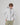 Model wearing white Henri-Lloyd Dynamic Lite Shell Jacket with hands in pockets.