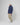 Person wearing Henri-Lloyd waterproof jacket with white beanie and beige trousers in studio setting