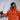A man in a boat with a waterproof jacket, waterproof salopettes, navy beanie and sailing gloves