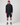 Model wearing Henri-Lloyd Men's Dynamic Jacket in black with black shorts, white socks, and trainers.