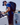Man wearing a backpack stepping on to a sailing boat. 