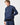 Model standing in three-quarter pose wearing the Dynamic Smock with one hand in pocket.
