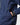 Side view close-up of model wearing a men's sailing smock, hand placed in front pocket with water-resistant zip.
