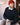Navy cable knit sweater styled with red beanie onboard yacht.