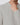 Close up of light grey cable knit sweater with ribbed neckline.