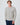 Light grey cable knit sweater with crew neck and textured knit.