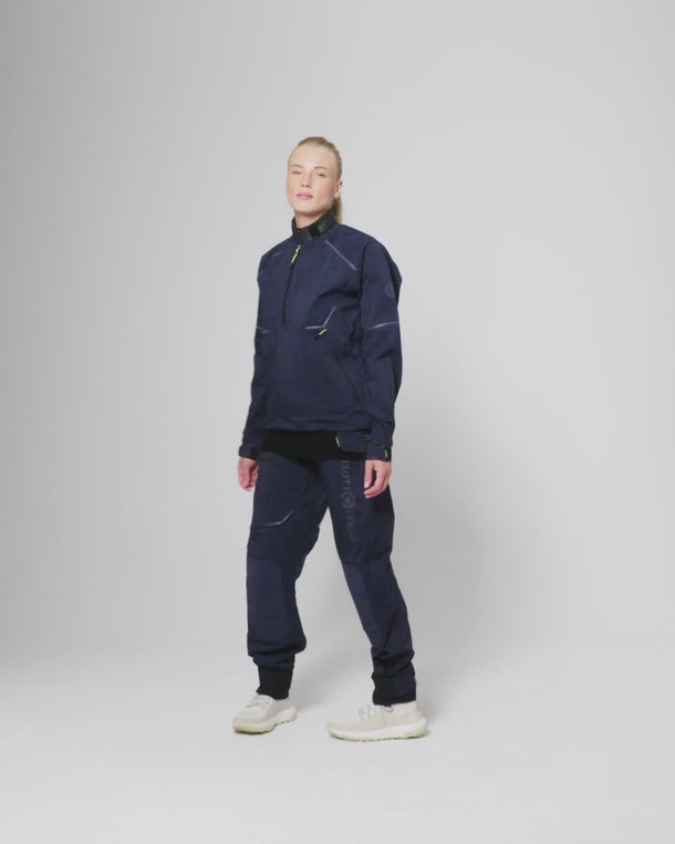 Model standing in the Dynamic Smock with matching sailing trousers against a plain background.