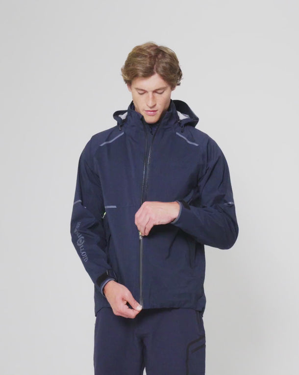 Model wearing the Henri-Lloyd Men's Dynamic Jacket in Navy, showing the front zip fastening.